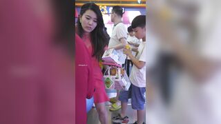 観光地で、白いワンピース姿の若い女性が写真を撮ろうとかがみ込む。カメラがその姿を至近距離までズームアップし、執拗に追尾・撮影し続けること ipcam 1